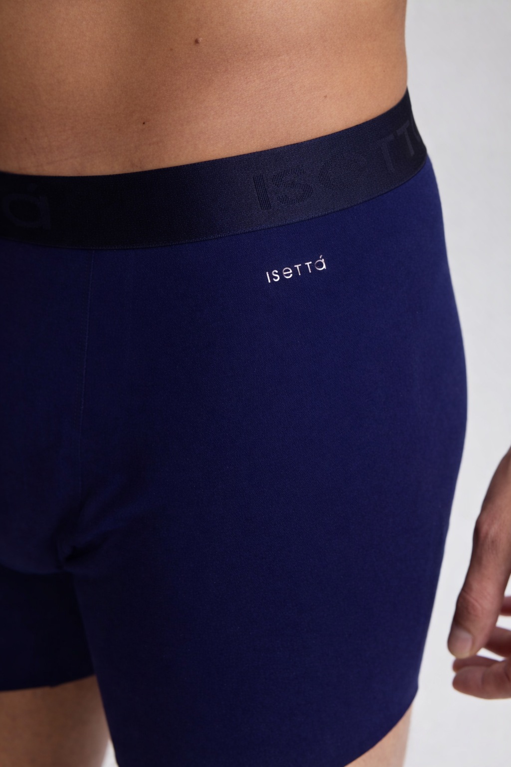 Navy blue boxer briefs with a brand logo on a white background
