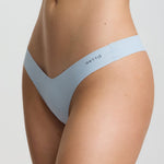 Person wearing light blue sports bra and underwear set on a plain background