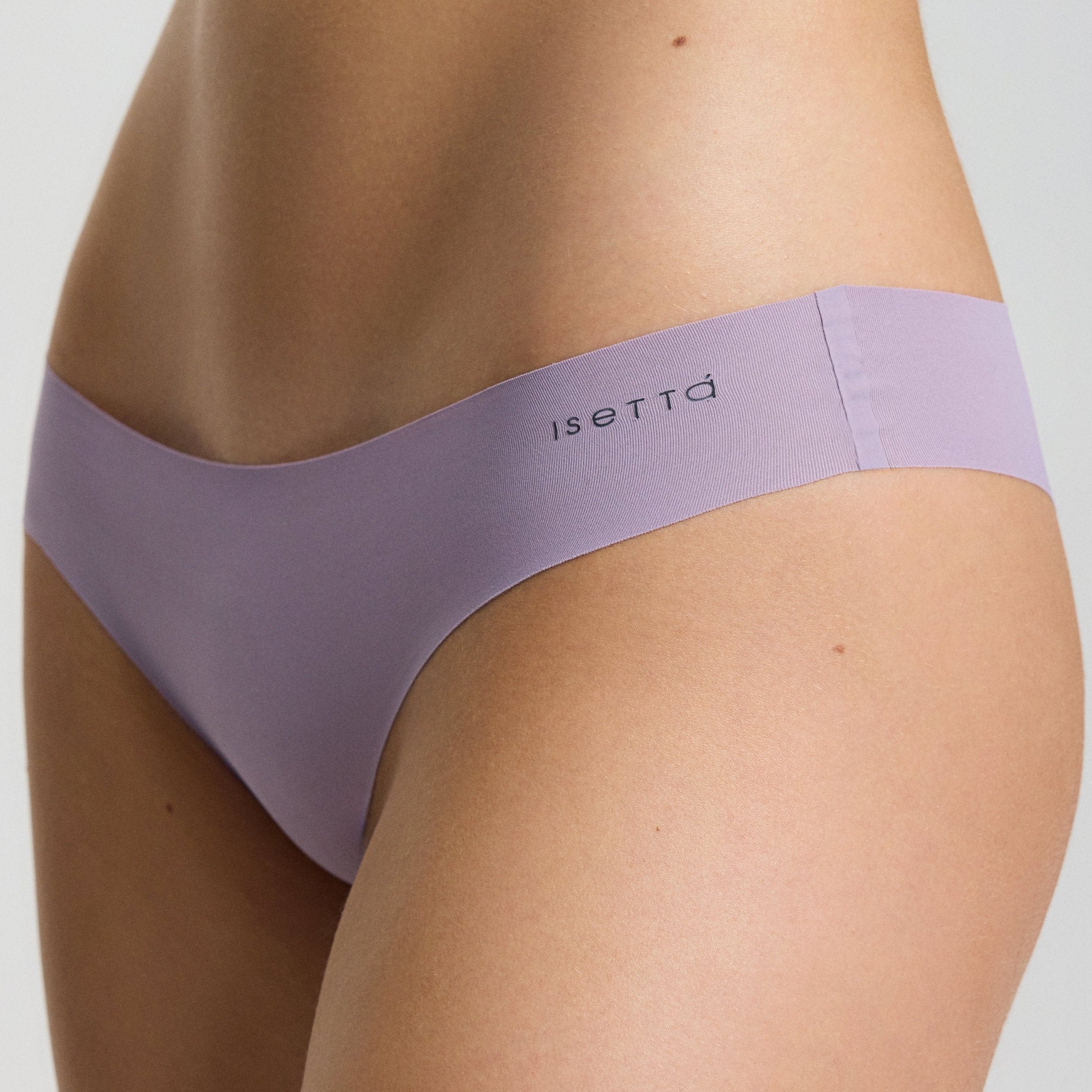 Purple underwear worn by a person on a light gray background