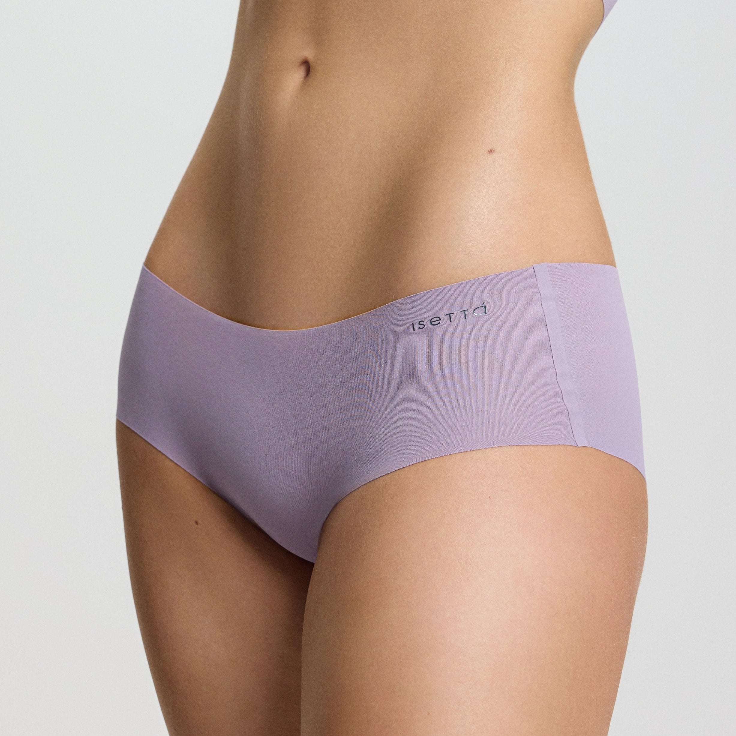 Person wearing a purple sports bra and underwear set on a light gray background