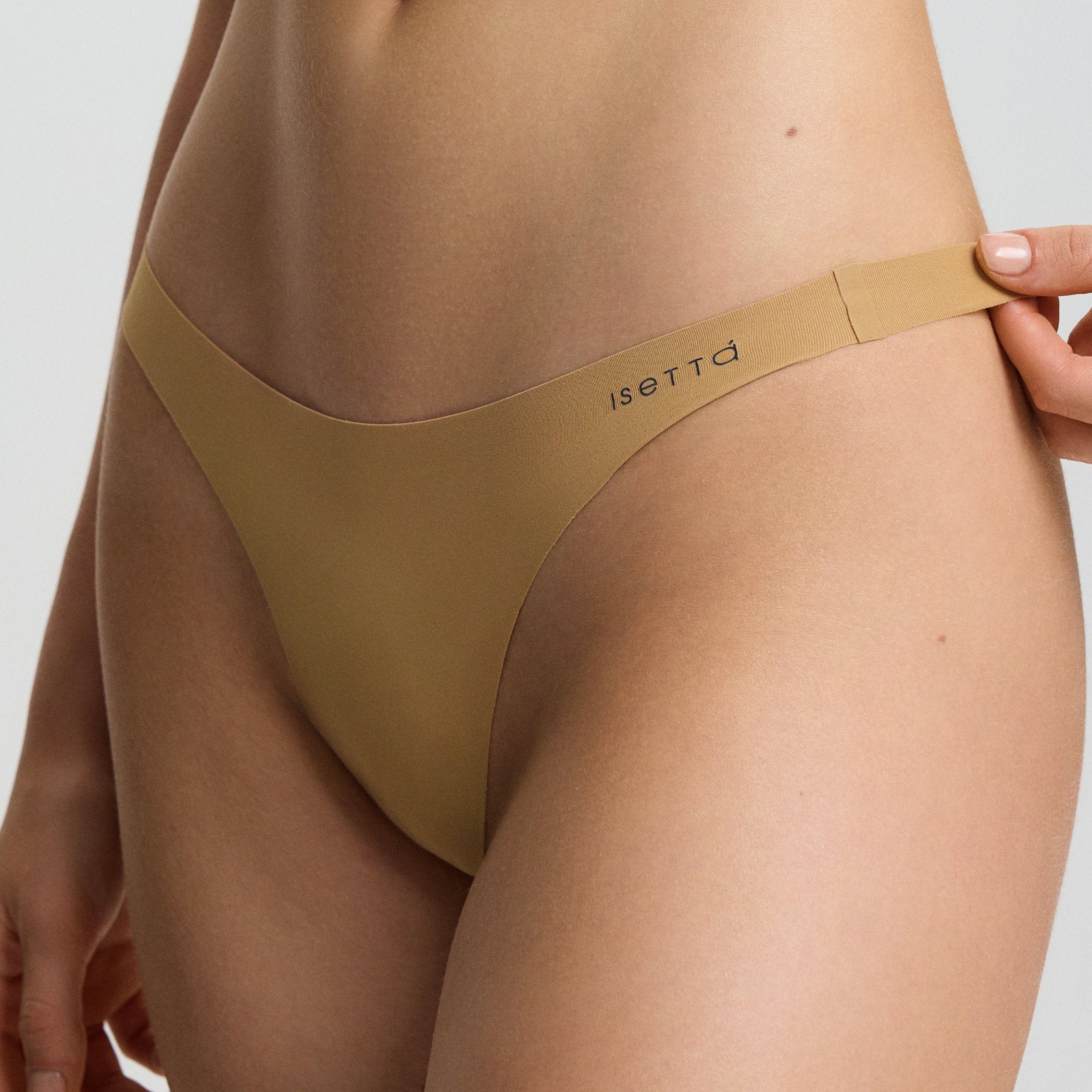 Person wearing a beige bikini set on a plain background