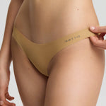 Beige lingerie set with 'Bella' branding on a plain background