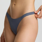 Person wearing a blue bikini on a plain background