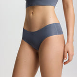 Person wearing a gray sports bra and underwear set on a light gray background