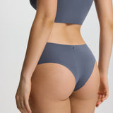 Person wearing a gray bikini set on a plain background