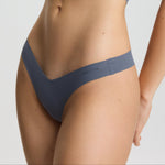 Person wearing a gray bikini set on a plain background