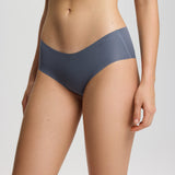 Person wearing dark gray underwear on a light gray background