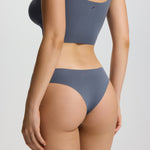 Person wearing a gray bikini set on a plain background