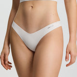 Person wearing a white bikini set on a plain background