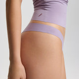 Person wearing a light purple athletic outfit on a plain background